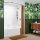 A green tropical bathroom with a white traditional tub and brown shower curtain