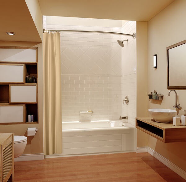 A nice bathroom with wooden floor and vanity, a white bathtub and caramel colored walls