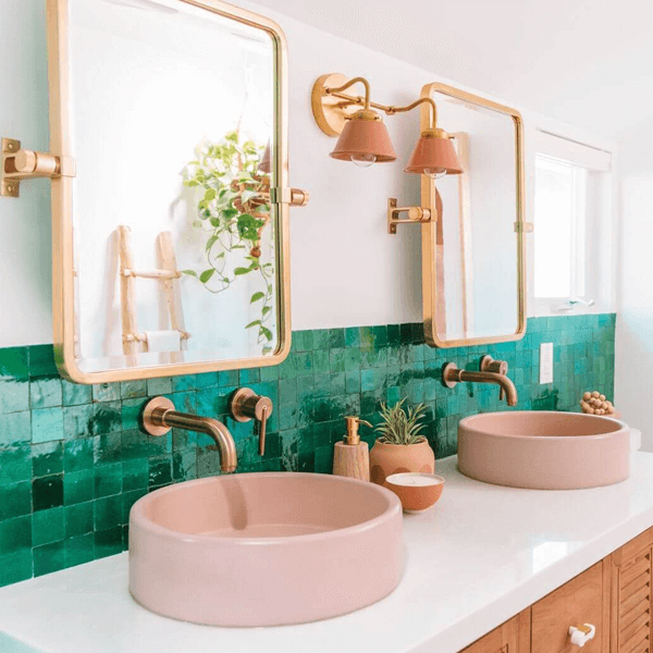 Green tiled splash back with double mirrors and salmon colored wash basins