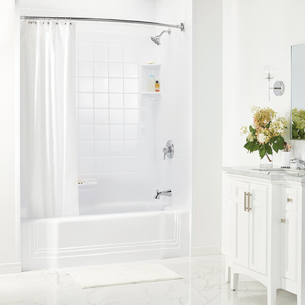 A clean, white bathroom and white vanity is on display in a bathroom.