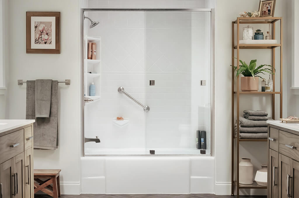 Clear glass shower door on a white tub