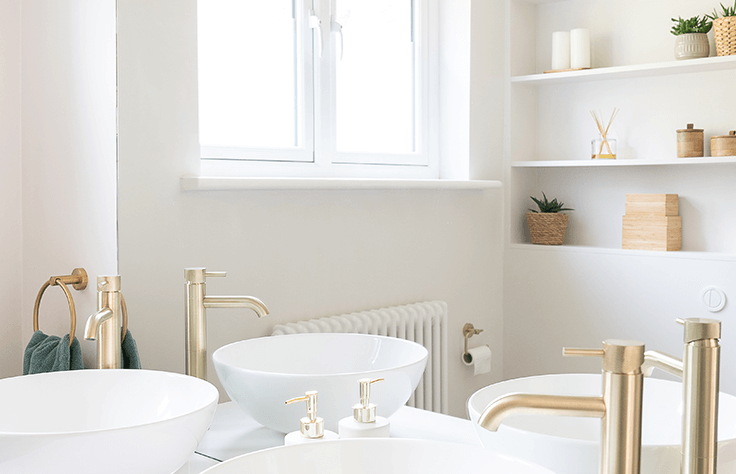 Two clean white sinks are sitting on a vanity