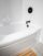 A beautiful clean white acrylic bathtub is the centerpiece of the bathroom